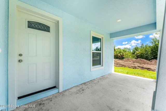 2100 Cogan Dr SE, Palm Bay, FL 32909 - property entrance with stucco siding