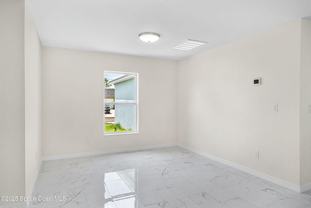 2100 Cogan Dr SE, Palm Bay, FL 32909 - empty room featuring visible vents, marble finish floor, a textured ceiling, and baseboards