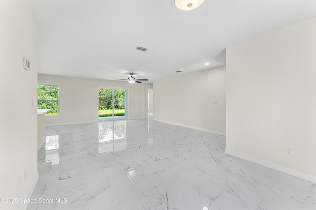2100 Cogan Dr SE, Palm Bay, FL 32909 - spare room with visible vents, a ceiling fan, marble finish floor, and baseboards