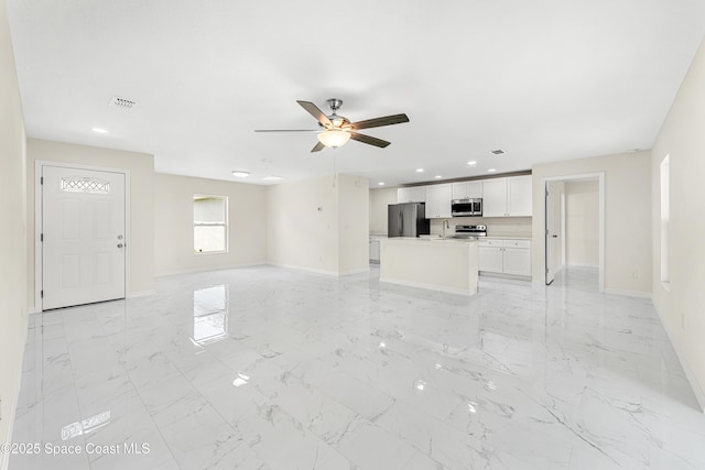 2100 Cogan Dr SE, Palm Bay, FL 32909 - unfurnished living room featuring visible vents, baseboards, ceiling fan, recessed lighting, and marble finish floor