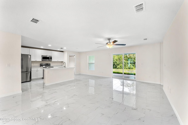 2100 Cogan Dr SE, Palm Bay, FL 32909 - unfurnished living room featuring a ceiling fan, visible vents, marble finish floor, and a sink