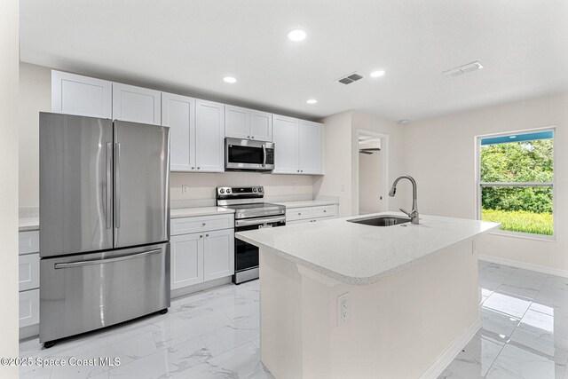 2100 Cogan Dr SE, Palm Bay, FL 32909 - kitchen featuring visible vents, marble finish floor, a sink, appliances with stainless steel finishes, and white cabinets