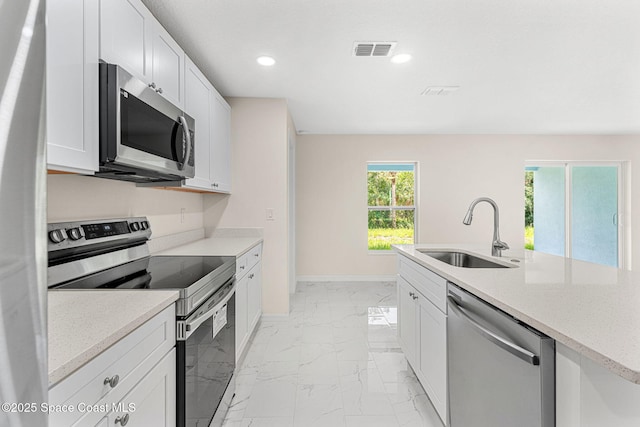 2100 Cogan Dr SE, Palm Bay, FL 32909 - kitchen with visible vents, recessed lighting, marble finish floor, stainless steel appliances, and a sink