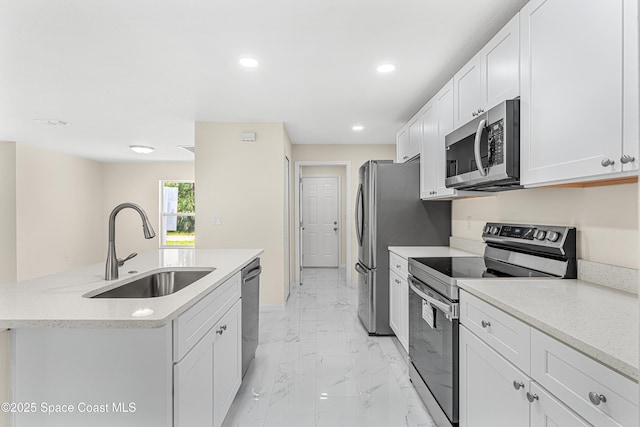 2100 Cogan Dr SE, Palm Bay, FL 32909 - kitchen featuring marble finish floor, a center island with sink, a sink, white cabinetry, and stainless steel appliances