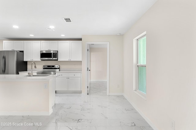 2100 Cogan Dr SE, Palm Bay, FL 32909 - kitchen with marble finish floor, a sink, recessed lighting, appliances with stainless steel finishes, and baseboards