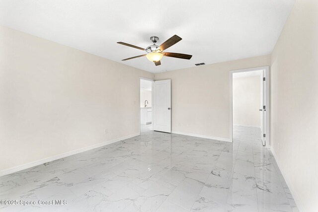 2100 Cogan Dr SE, Palm Bay, FL 32909 - unfurnished room with visible vents, baseboards, marble finish floor, and a ceiling fan