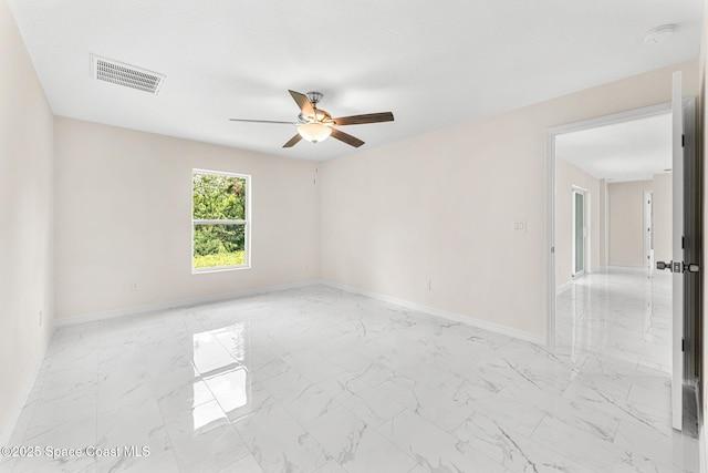 2100 Cogan Dr SE, Palm Bay, FL 32909 - unfurnished room featuring visible vents, a ceiling fan, marble finish floor, and baseboards