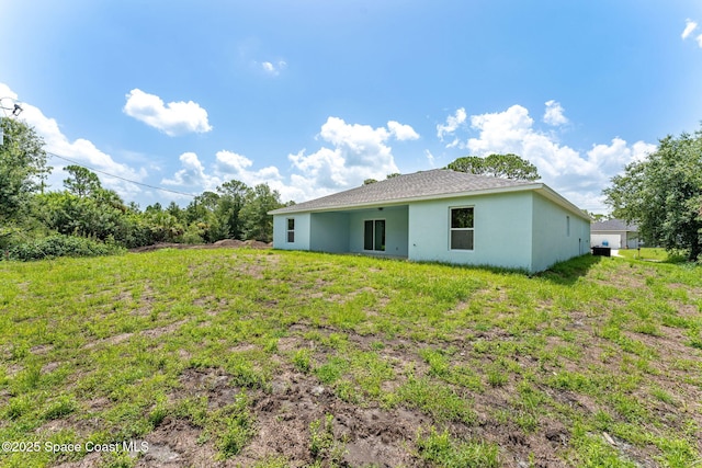 2100 Cogan Dr SE, Palm Bay, FL 32909 - rear view of property featuring stucco siding