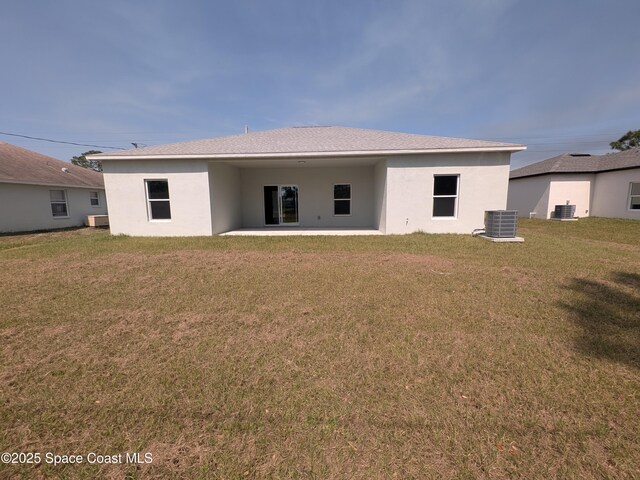 2100 Cogan Dr SE, Palm Bay, FL 32909 - back of property featuring central air condition unit, stucco siding, a patio, and a yard
