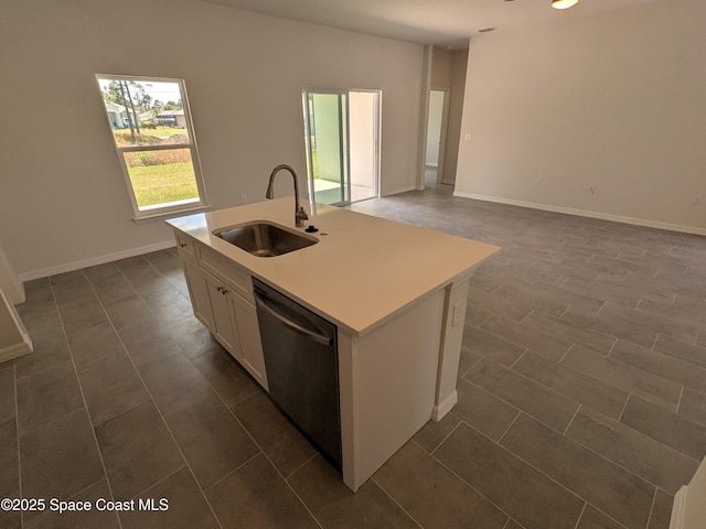 2100 Cogan Dr SE, Palm Bay, FL 32909 - kitchen featuring a center island with sink, white cabinetry, a sink, light countertops, and stainless steel dishwasher