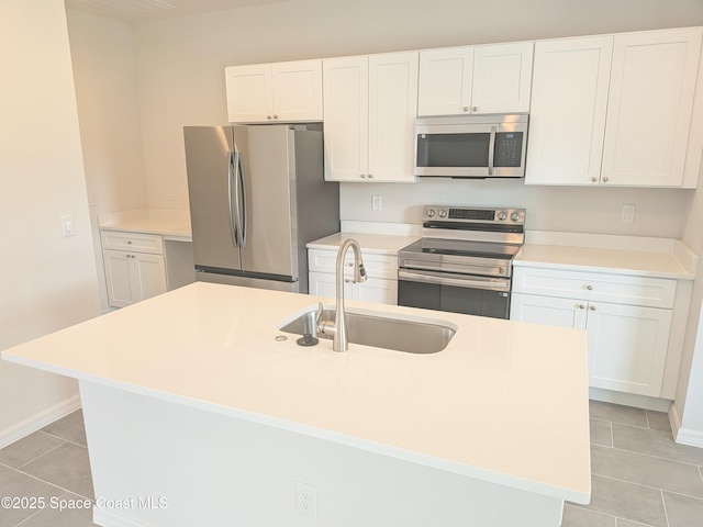 2100 Cogan Dr SE, Palm Bay, FL 32909 - kitchen with light countertops, light tile patterned flooring, white cabinets, stainless steel appliances, and a sink