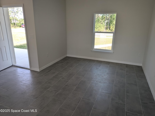 2100 Cogan Dr SE, Palm Bay, FL 32909 - spare room featuring baseboards