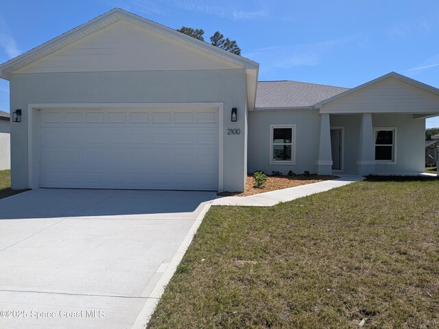 2100 Cogan Dr SE, Palm Bay, FL 32909 - ranch-style house with stucco siding, an attached garage, driveway, and a front lawn