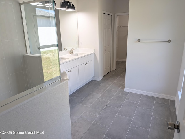 2100 Cogan Dr SE, Palm Bay, FL 32909 - bathroom featuring tile patterned flooring, a spacious closet, vanity, and baseboards
