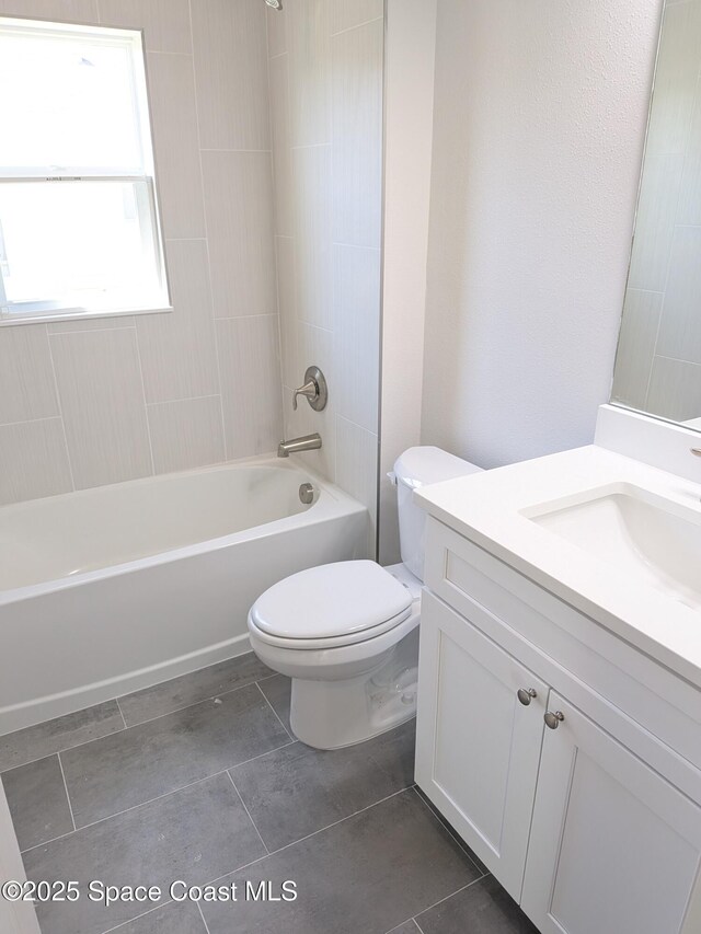 2100 Cogan Dr SE, Palm Bay, FL 32909 - bathroom featuring toilet, vanity, and shower / tub combination
