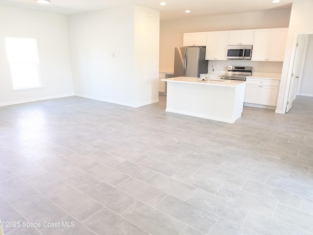 2100 Cogan Dr SE, Palm Bay, FL 32909 - kitchen featuring open floor plan, recessed lighting, appliances with stainless steel finishes, light countertops, and baseboards
