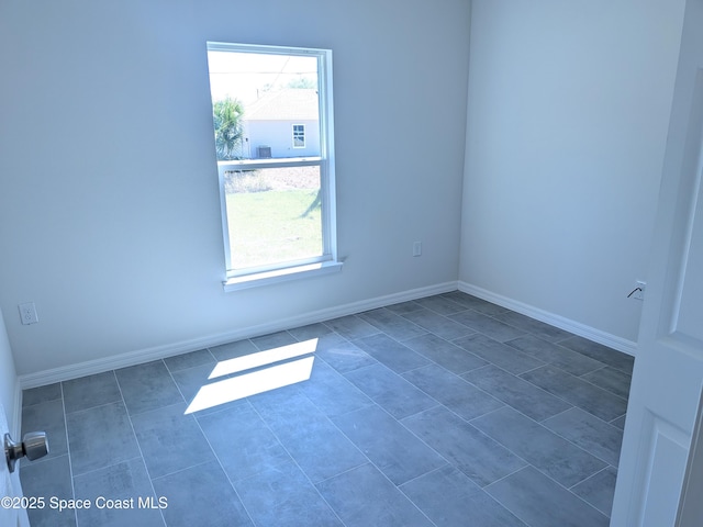 2100 Cogan Dr SE, Palm Bay, FL 32909 - empty room featuring baseboards and plenty of natural light