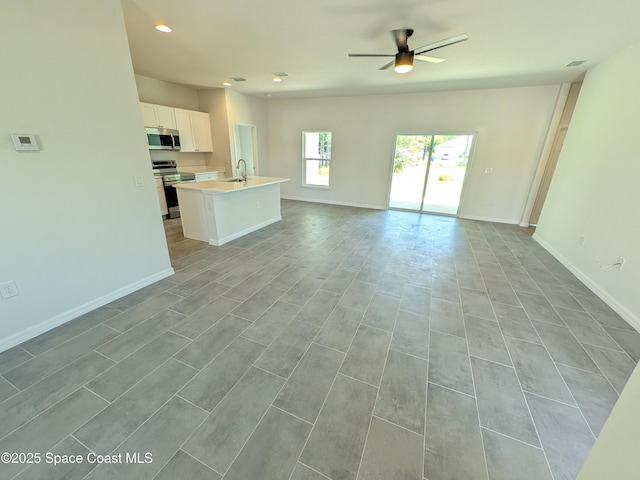 2100 Cogan Dr SE, Palm Bay, FL 32909 - unfurnished living room with a sink, recessed lighting, baseboards, and ceiling fan