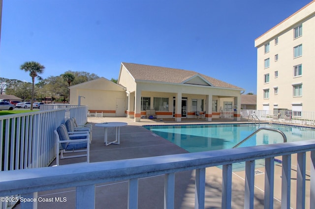 community pool featuring a patio area and fence