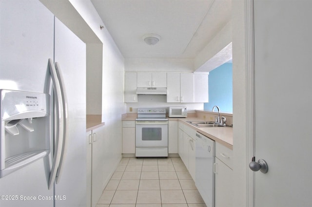 kitchen featuring light countertops, white cabinets, a sink, white appliances, and under cabinet range hood