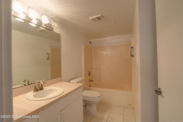 bathroom with a textured ceiling, tile patterned flooring, toilet, vanity, and visible vents