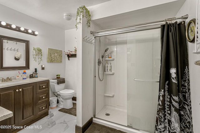 full bathroom with a stall shower, vanity, and toilet