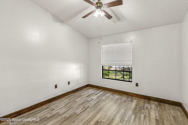 unfurnished room featuring a ceiling fan, a textured ceiling, baseboards, and wood finished floors