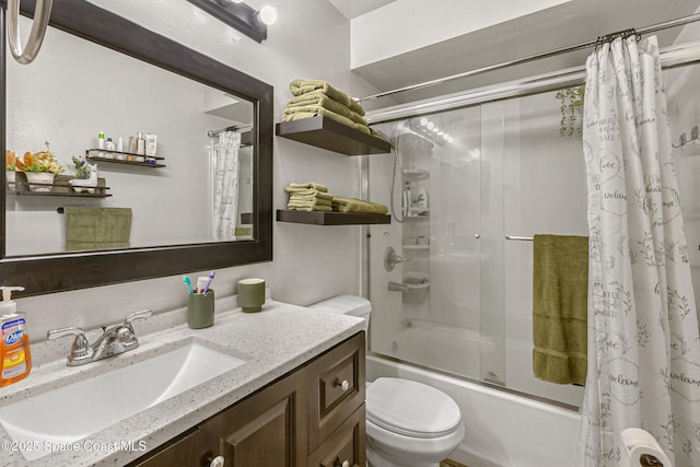 bathroom with combined bath / shower with glass door, vanity, and toilet