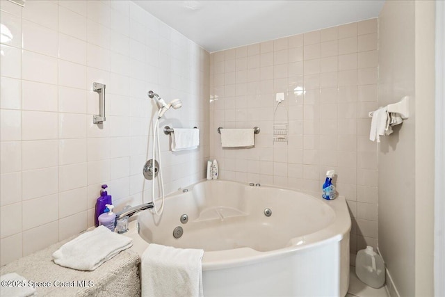 full bathroom featuring tile walls and a tub with jets