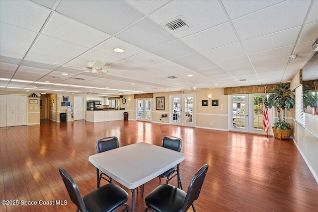 dining space featuring french doors, visible vents, ceiling fan, and hardwood / wood-style floors