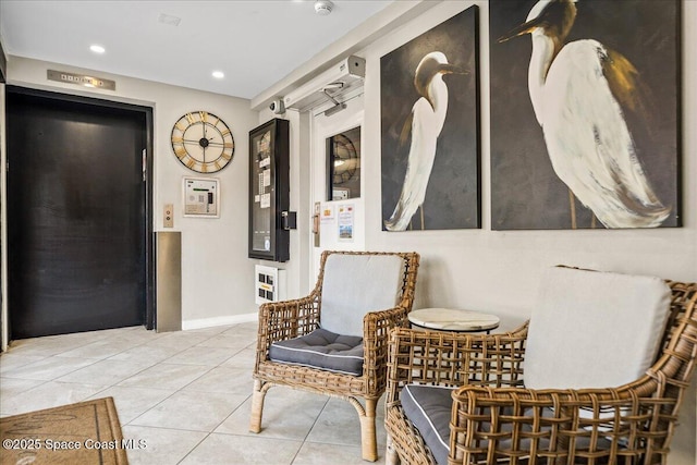 sitting room with tile patterned flooring, baseboards, and recessed lighting