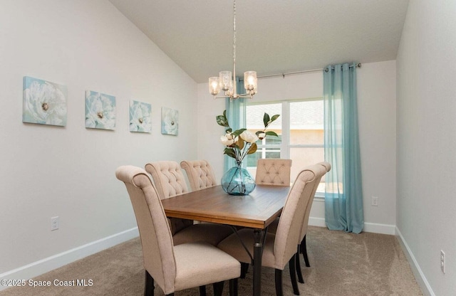 dining room with carpet, a chandelier, vaulted ceiling, and baseboards