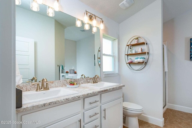 bathroom featuring toilet, a sink, a shower stall, tile patterned floors, and double vanity