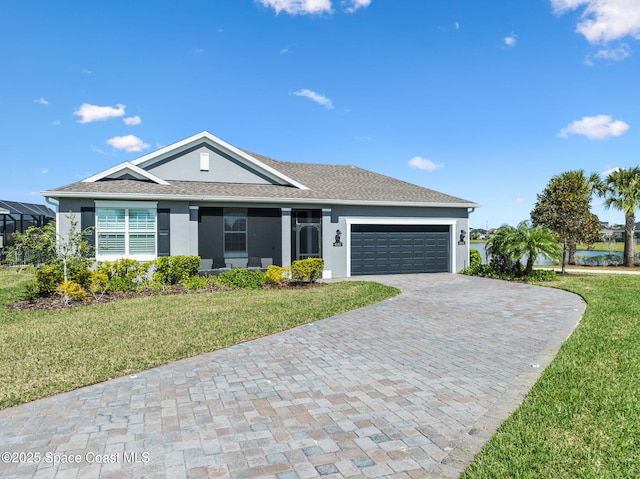 ranch-style home featuring a front lawn, decorative driveway, an attached garage, and stucco siding