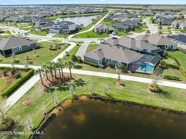 birds eye view of property featuring a water view and a residential view