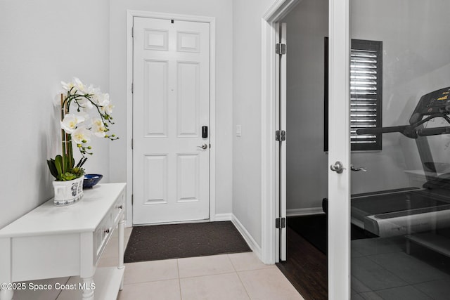 entrance foyer with baseboards and light tile patterned floors