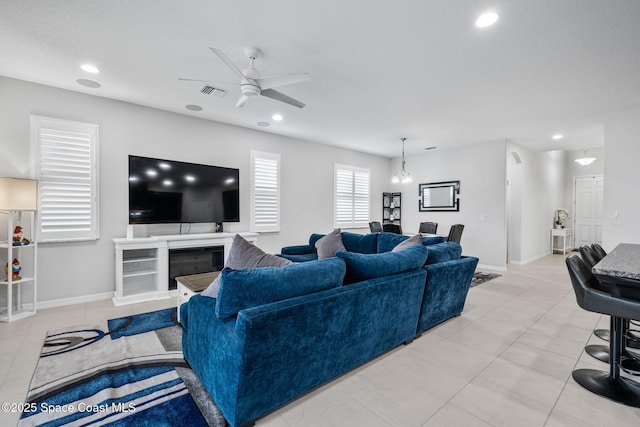 living area featuring baseboards, recessed lighting, visible vents, and a ceiling fan