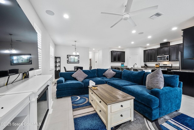 living area with light tile patterned flooring, visible vents, and recessed lighting