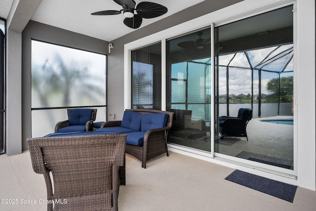 view of patio / terrace with outdoor lounge area, a lanai, a ceiling fan, and an outdoor pool