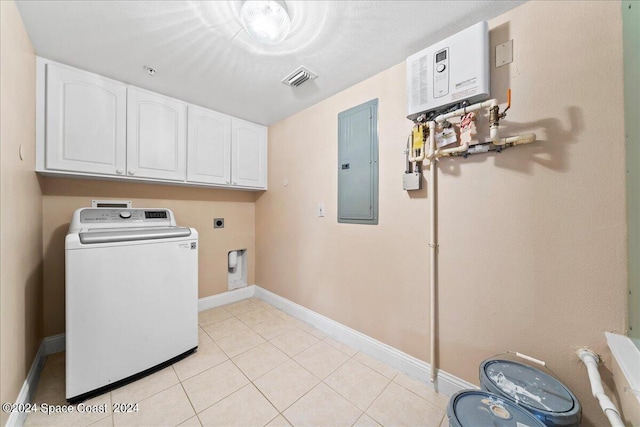 clothes washing area featuring washer / clothes dryer, cabinet space, light tile patterned flooring, electric panel, and baseboards