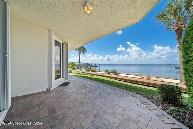 view of patio with a water view