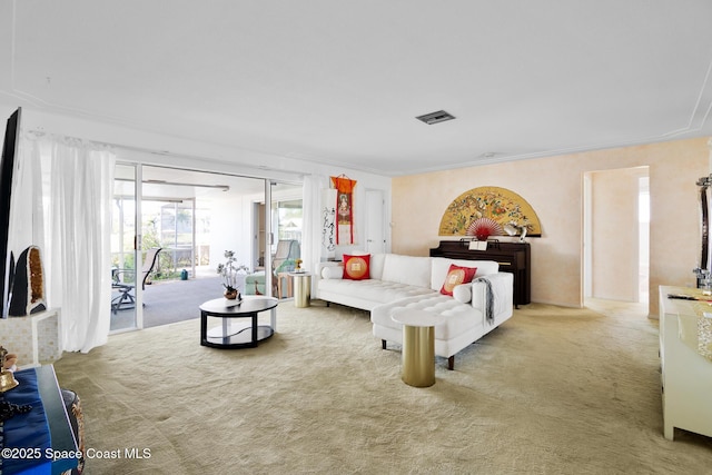 carpeted living room with visible vents and crown molding