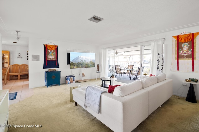 carpeted living room featuring visible vents and tile patterned floors