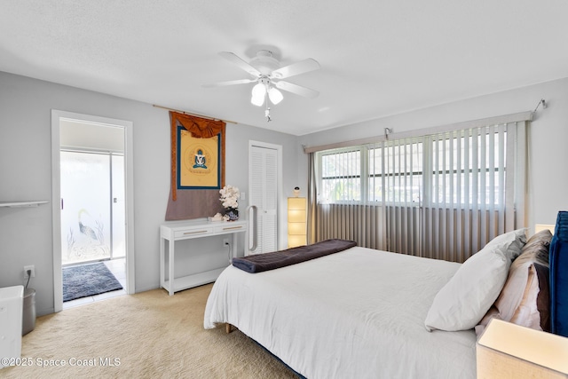 bedroom featuring a closet, a ceiling fan, and light colored carpet