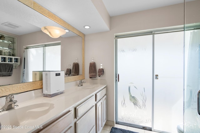 bathroom with double vanity, visible vents, a sink, and an enclosed shower