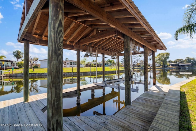 dock area with a water view and boat lift