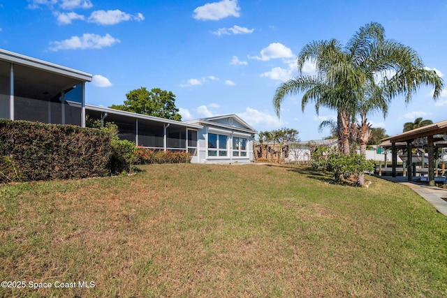 view of yard with a sunroom