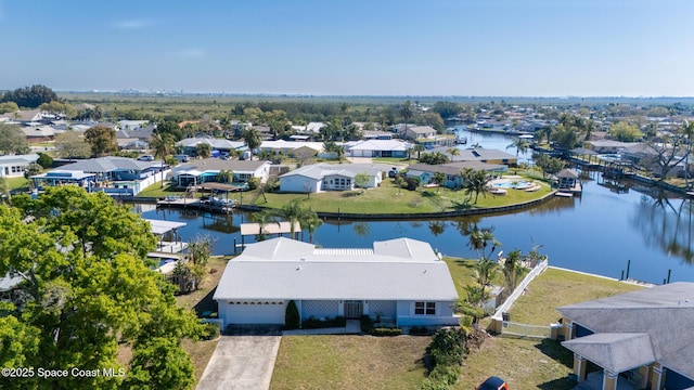 drone / aerial view featuring a water view and a residential view