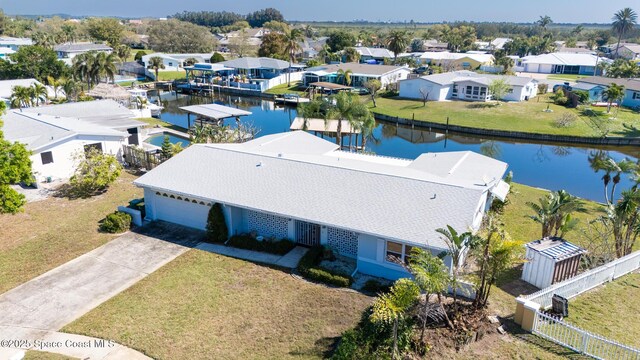 birds eye view of property featuring a residential view and a water view