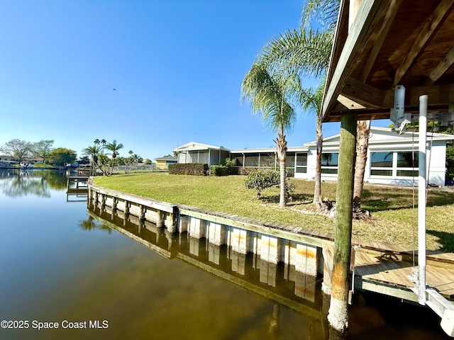 dock area featuring a water view and a yard